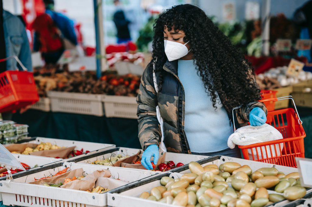 woman comparing prices while grocery shopping