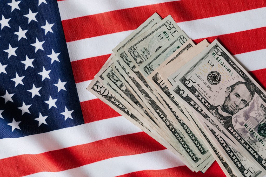 American money in front of an American flag.