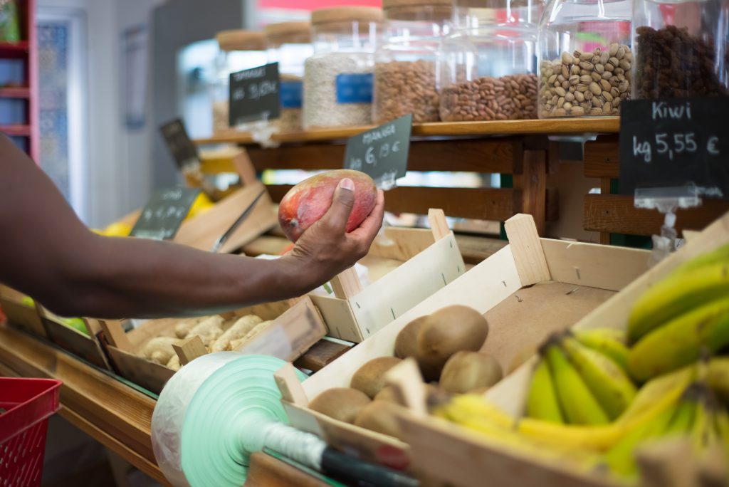 A person looking at vegetables while grocery shopping.