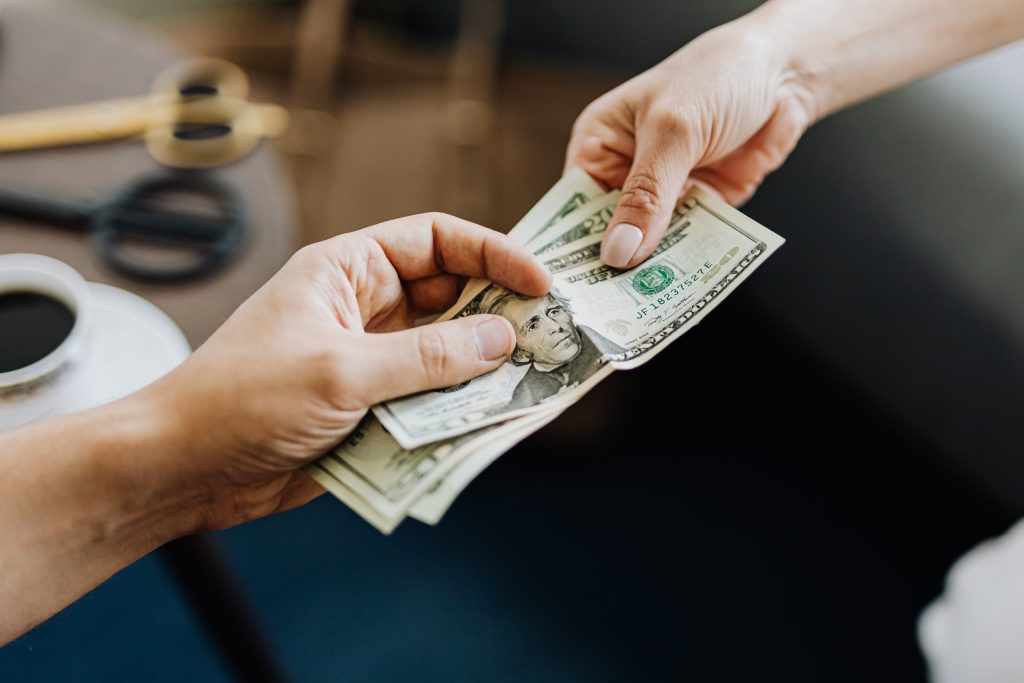 Two people exchanging money.