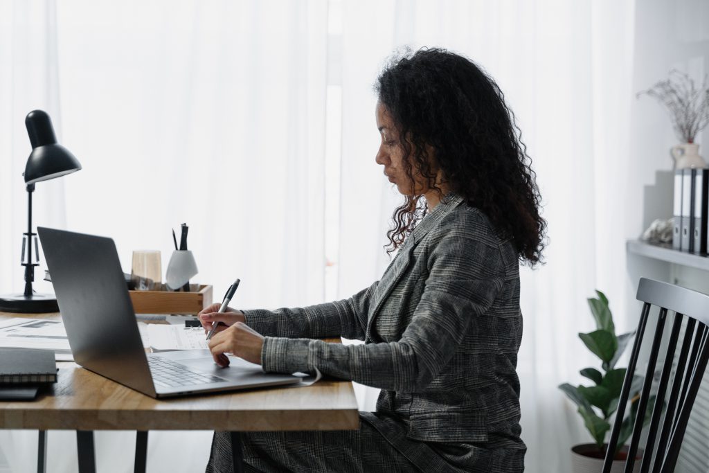 A woman working on her laptop.