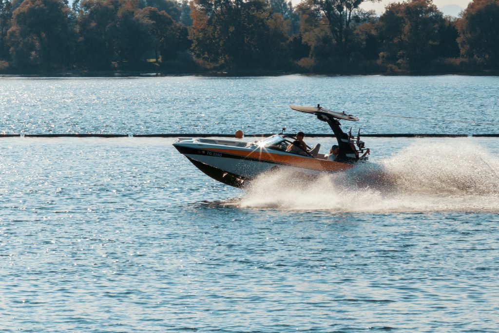 A person on a speed boat in a large body of water.