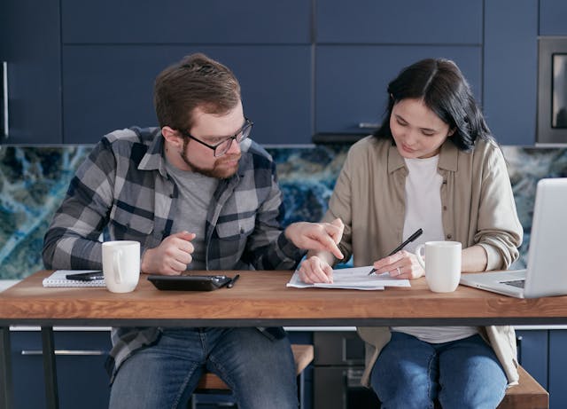 A man and a woman looking at documents together.