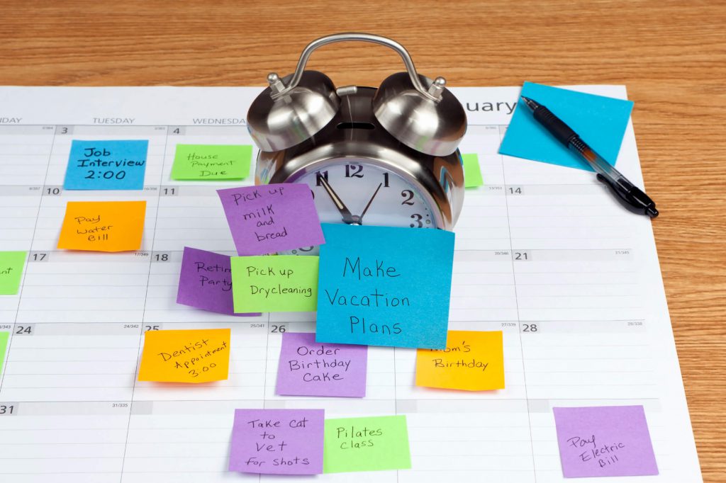 An alarm clock covered in sticky notes.